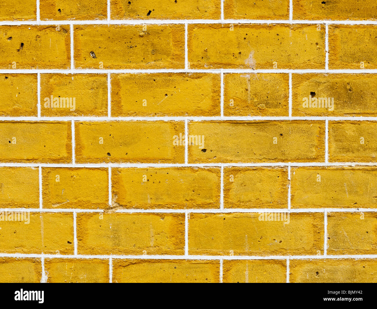 Ausschnitt aus gelbem Backsteinwand Stockfoto