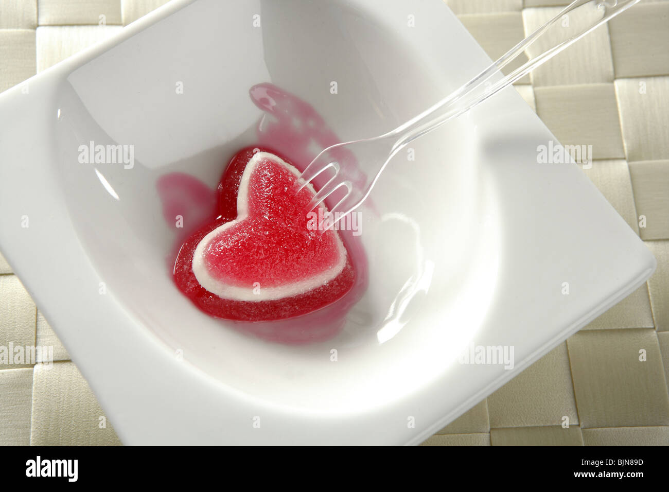 Essen Sie Gelee Erdbeere blutige Herz romantische Metapher Stockfoto