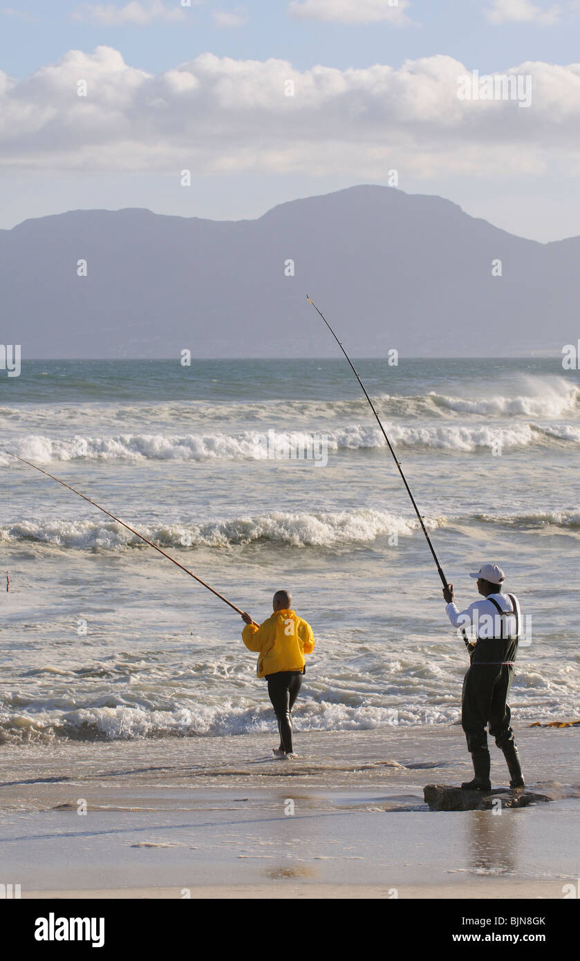 Männer Angeln vom Strand an der False Bay bei Muizenberg in der western Cape Südafrika Stockfoto