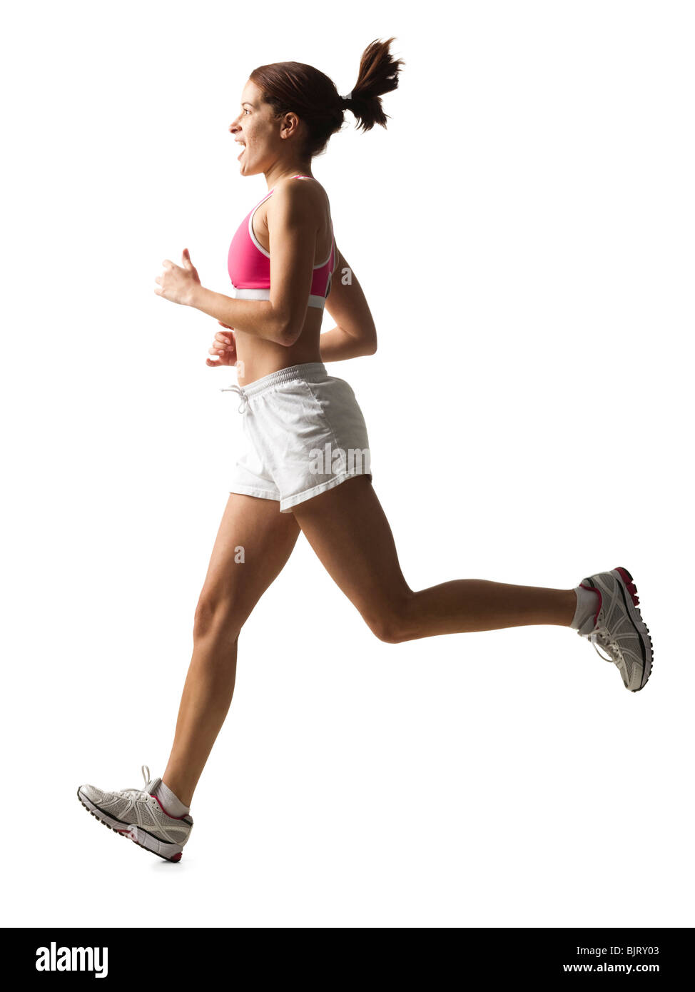 Junge Frau läuft, Studio gedreht Stockfoto