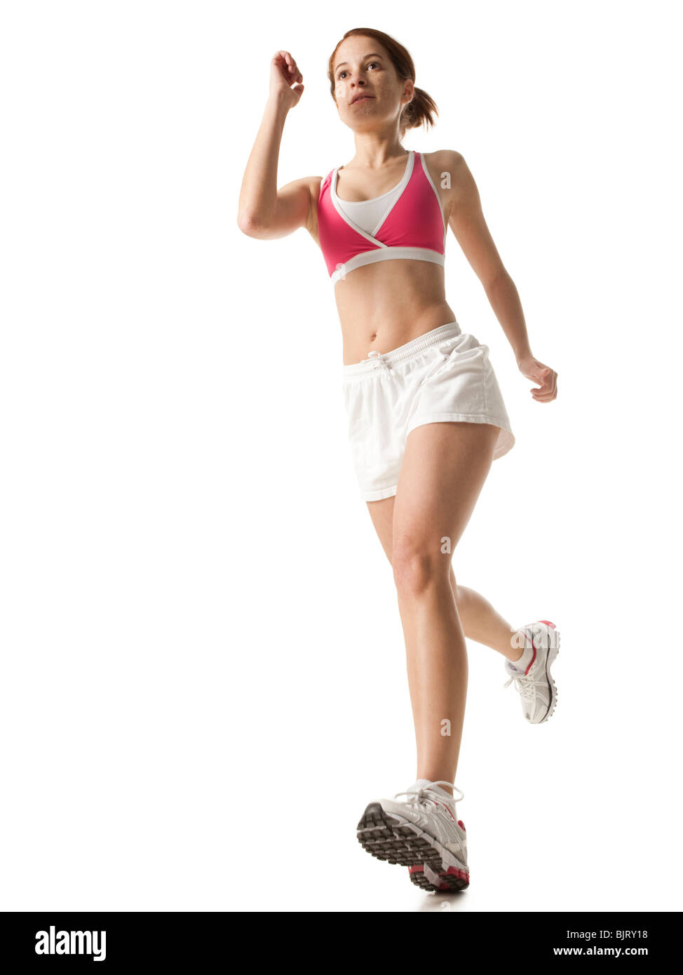 Junge Frau Powerwalking, Studioaufnahme Stockfoto