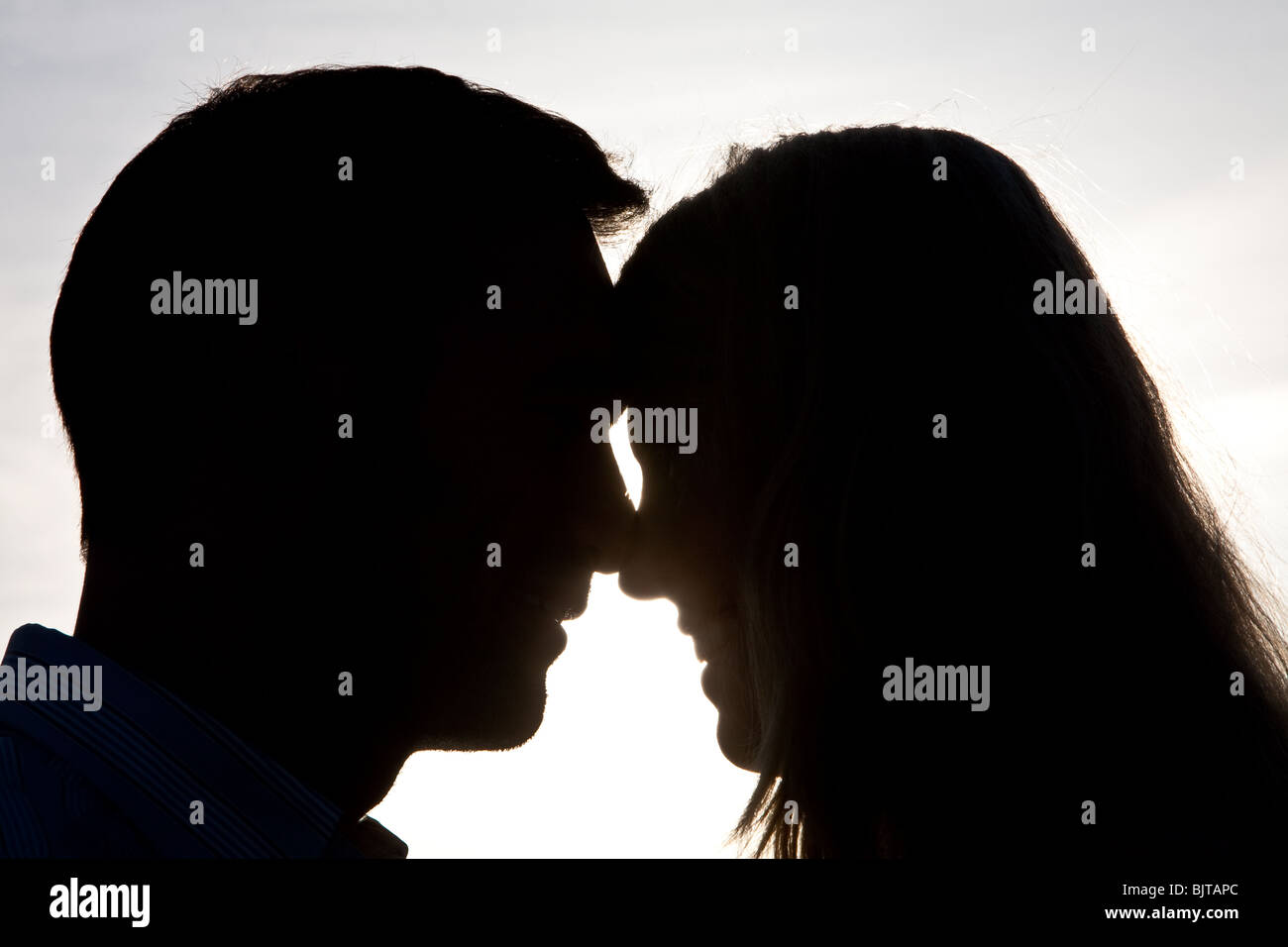 Romantisch zu zweit in Silhouette Hintergrundbeleuchtung bei Sonnenuntergang Stockfoto