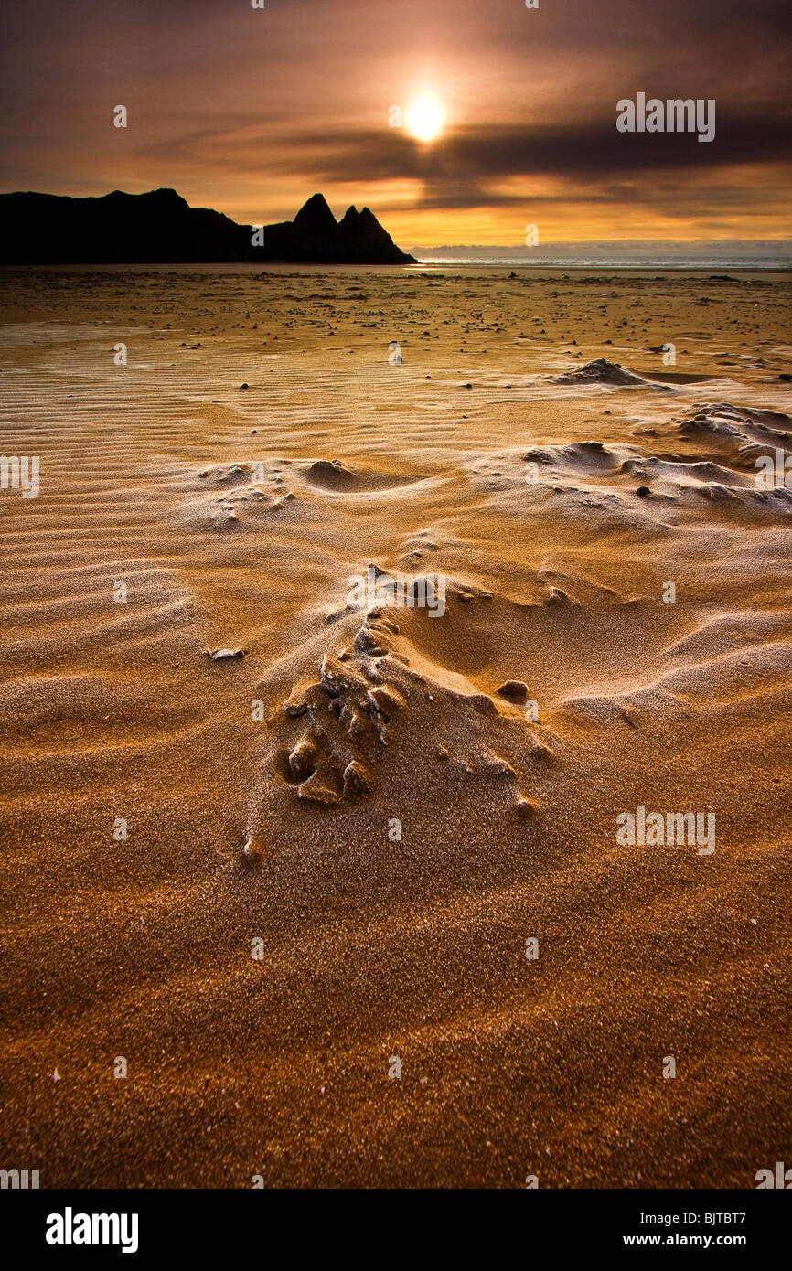 Gefrorenen Sand bei Sonnenaufgang, Three Cliffs Bay, Gower. Stockfoto