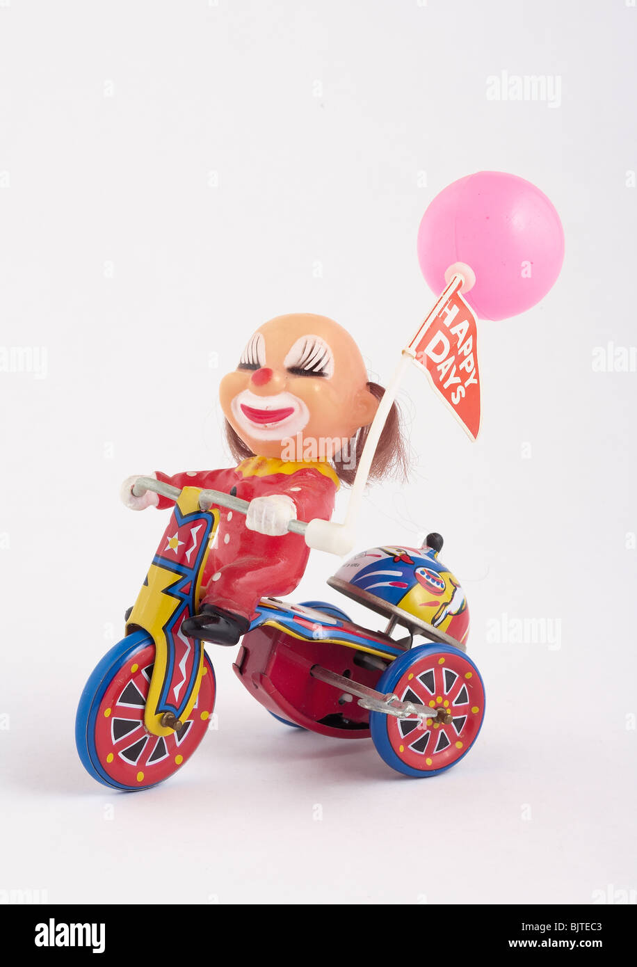antikes Spielzeug Clown auf Metall Windup Dreirad Stockfoto