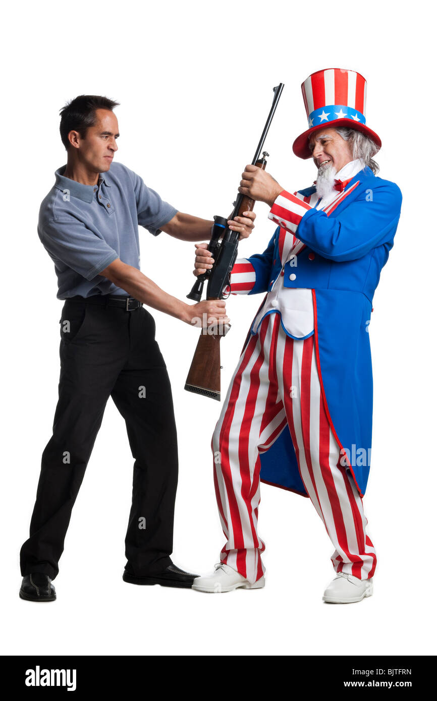 Mann in Uncle Sam Kostüm Beschlagnahme Pistole von anderen Menschen, Studio gedreht Stockfoto