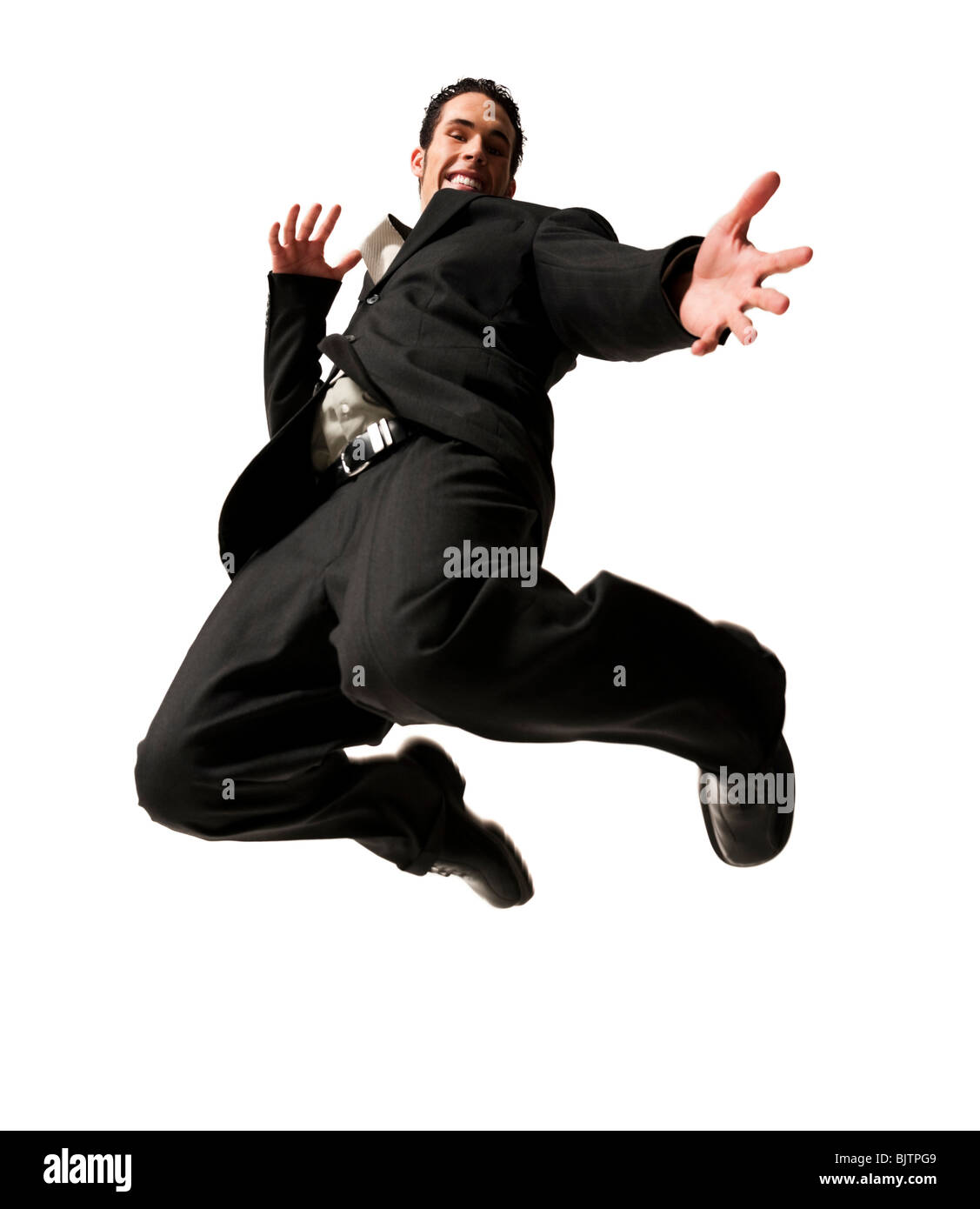 Mann springt mit gestreckten Stockfoto