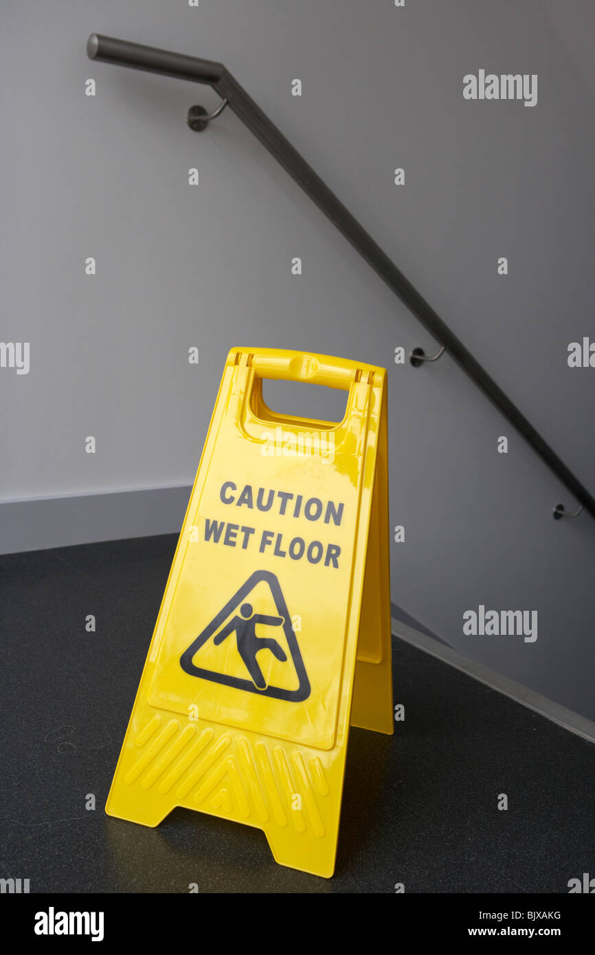 Vorsicht nassen Boden Zeichen am oberen Rand eine Reihe von Treppen in einem modernen Gebäude Stockfoto