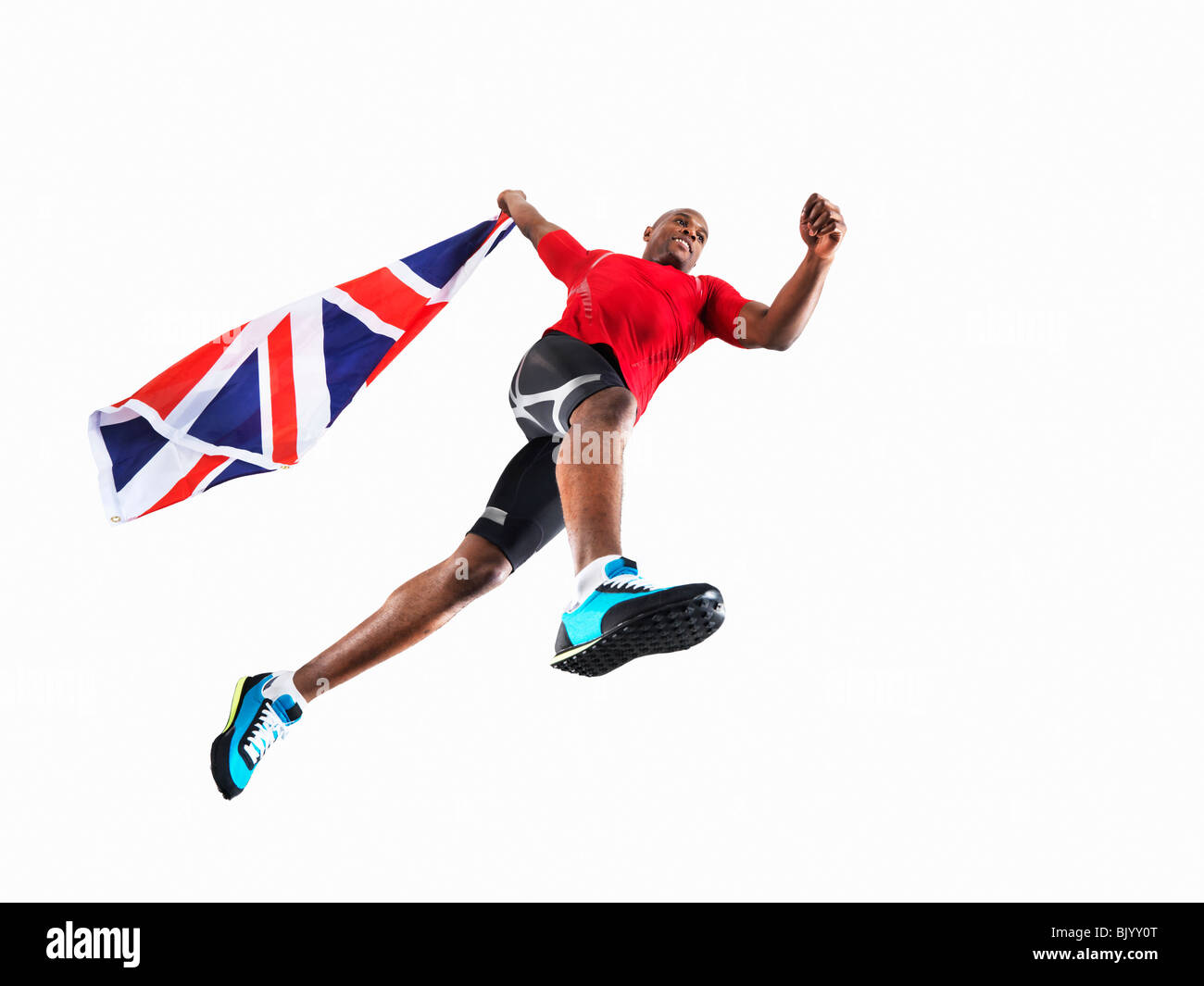 Männlicher Athlet läuft mit Union jack Stockfoto