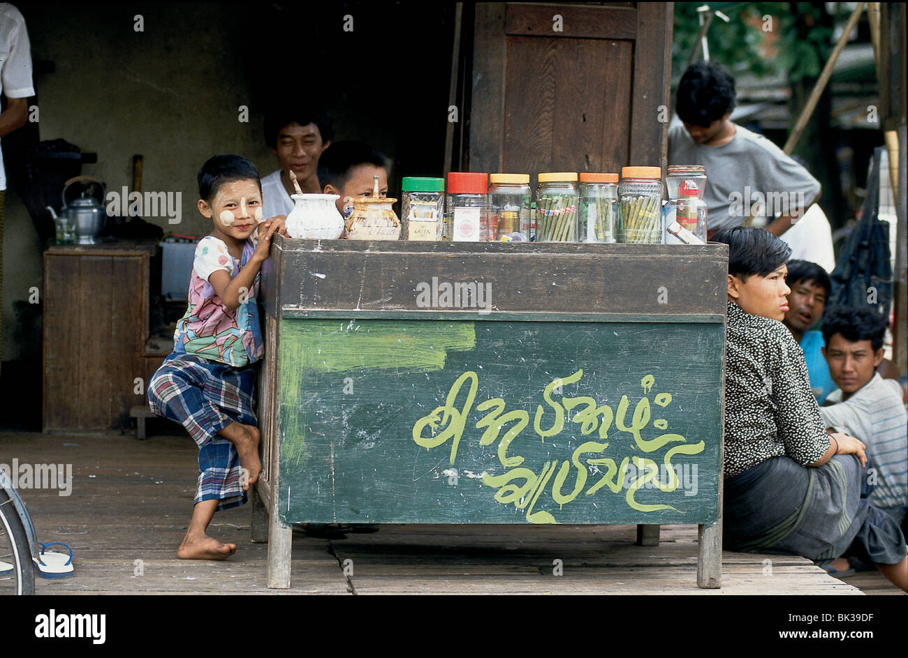 Ein Kind mit bemaltem Gesicht stand ein Tabak, Zigarre Hersteller Stand, Myanmar Stockfoto
