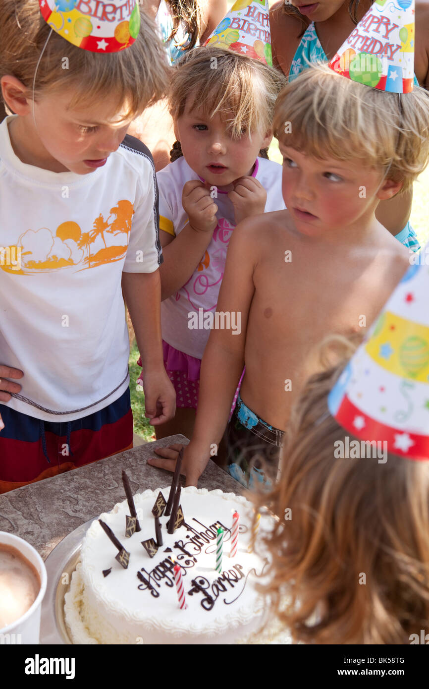 Kinder um Kuchen am Geburtstag Stockfoto