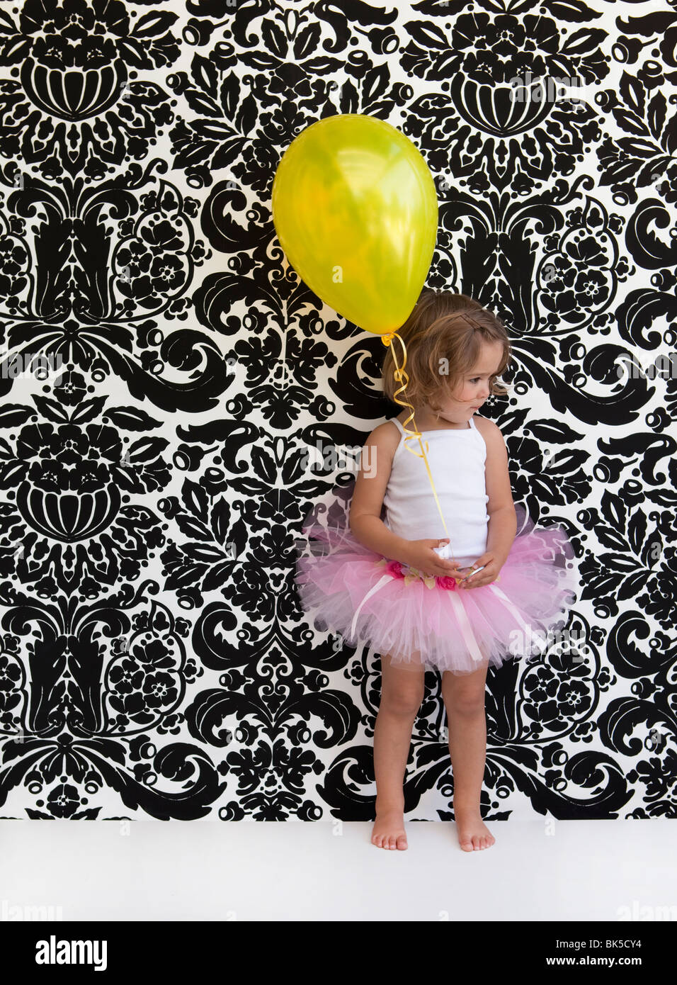 Kleines Mädchen mit rosa Tutu und gelben Ballon Stockfoto