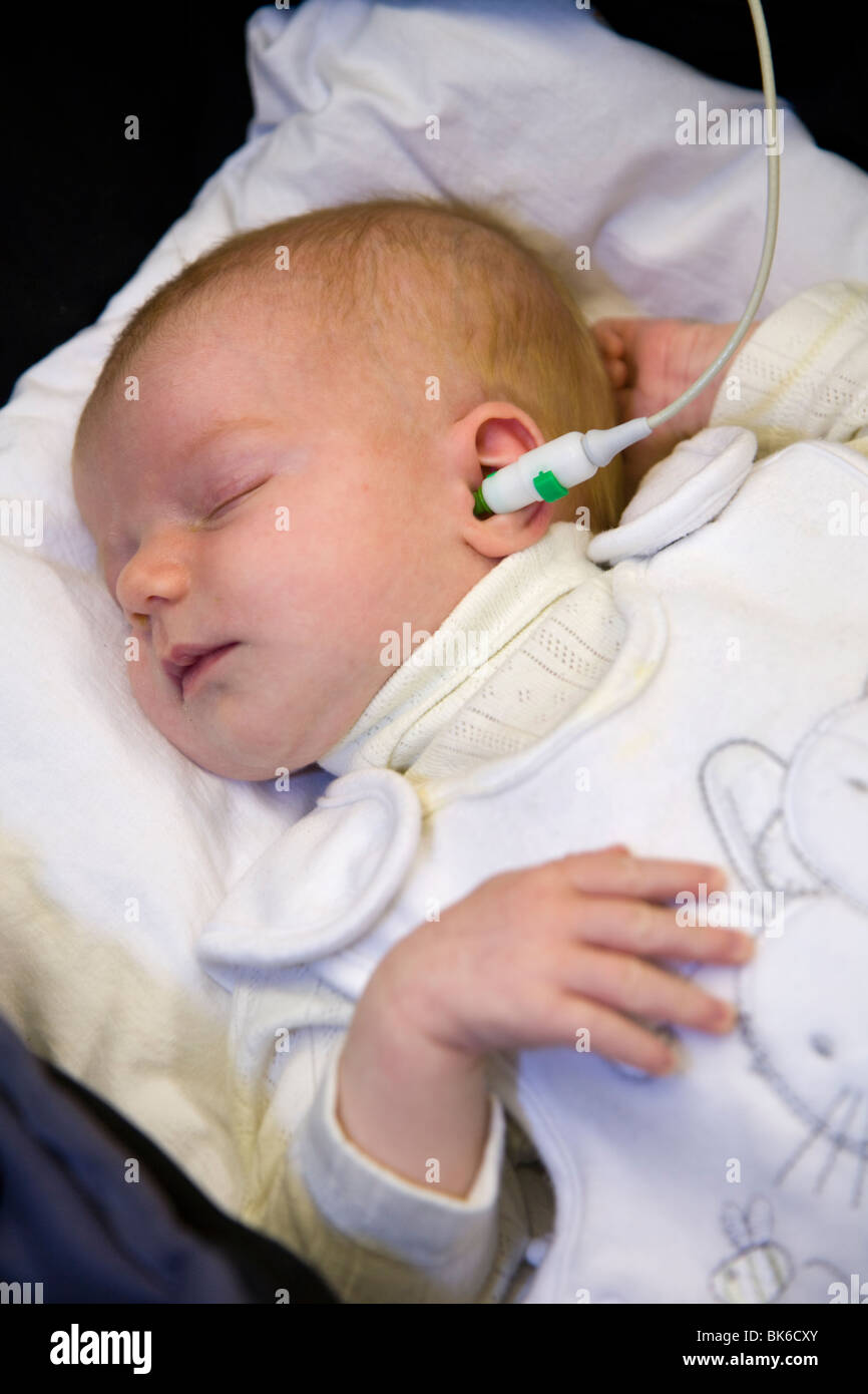 Neugeborene / new born Baby durchläuft einen Neugeborenen Hörscreening Test: automatisierte otoakustischen Emissionen Test. Stockfoto