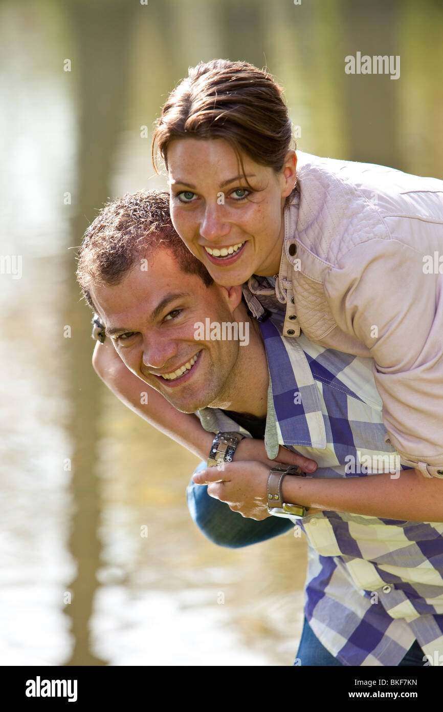 Süße junge Paar tun eine Huckepack Reiten im freien Stockfoto
