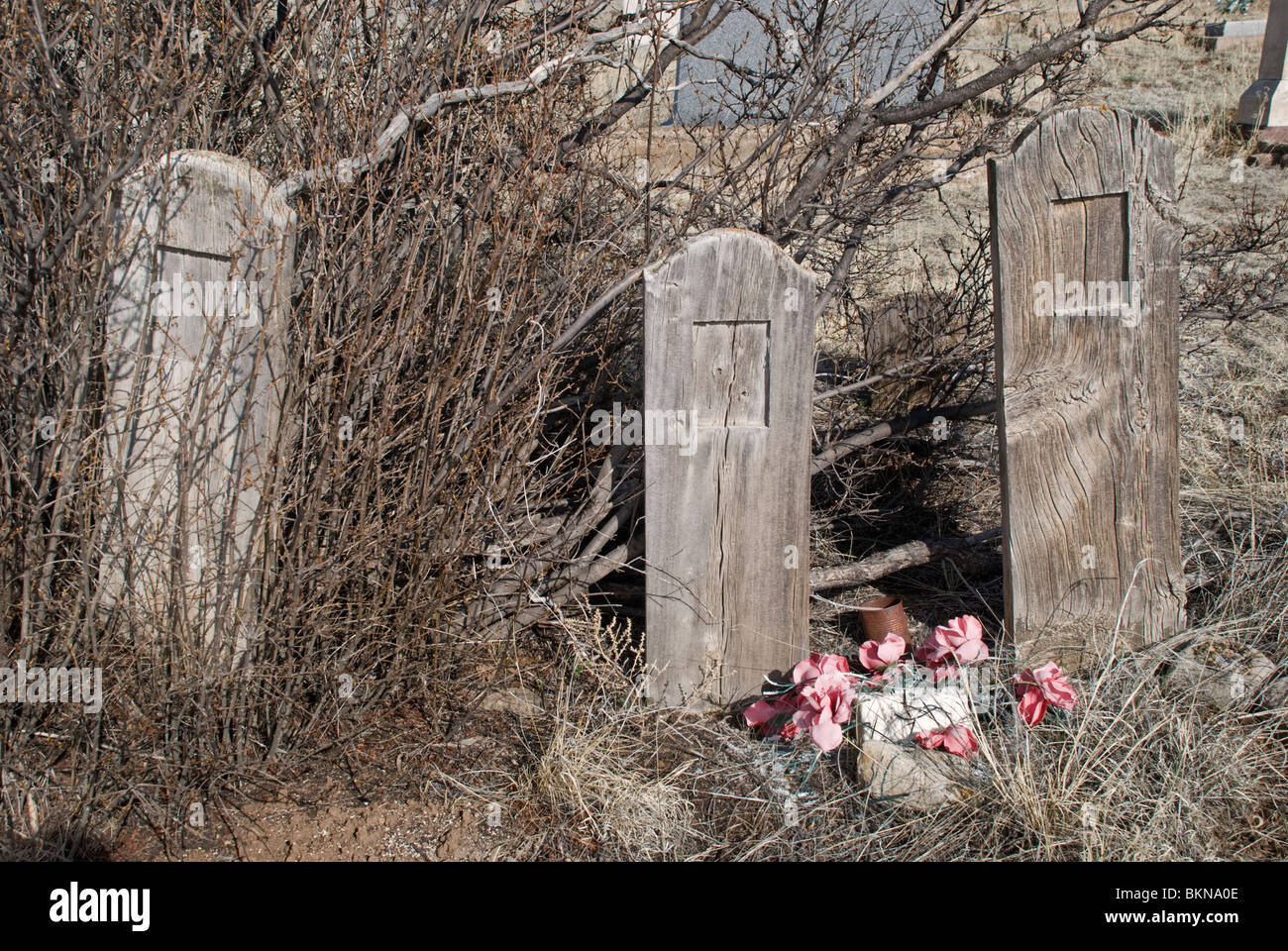 Drei alte Friedhof Markierungen kennzeichnen nicht identifizierte Grabstellen in einer vergessenen Friedhofs in der Geisterstadt von White Oaks, New Mexico. Stockfoto