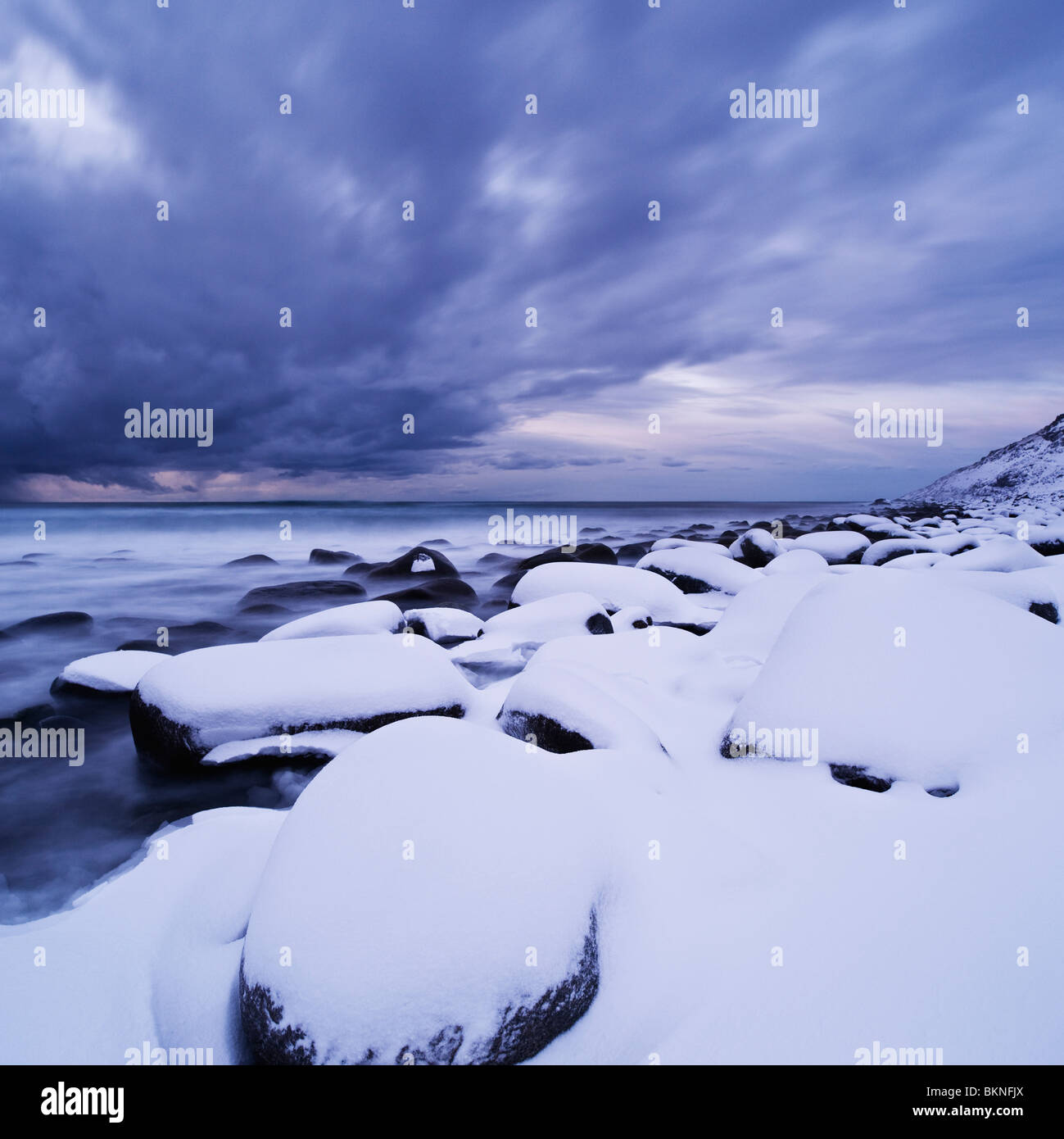 Schneebedeckte Felsen am Strand Unstad, Leknes, Lofoten Inseln, Norwegen Stockfoto