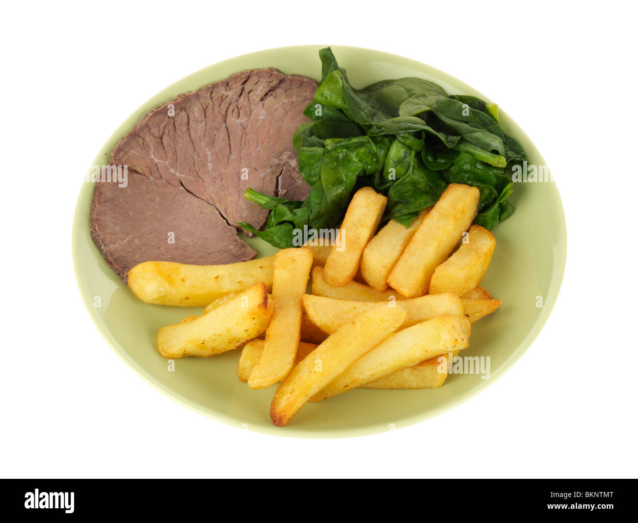 Rindfleisch mit Pommes Frites und Spinat Stockfoto