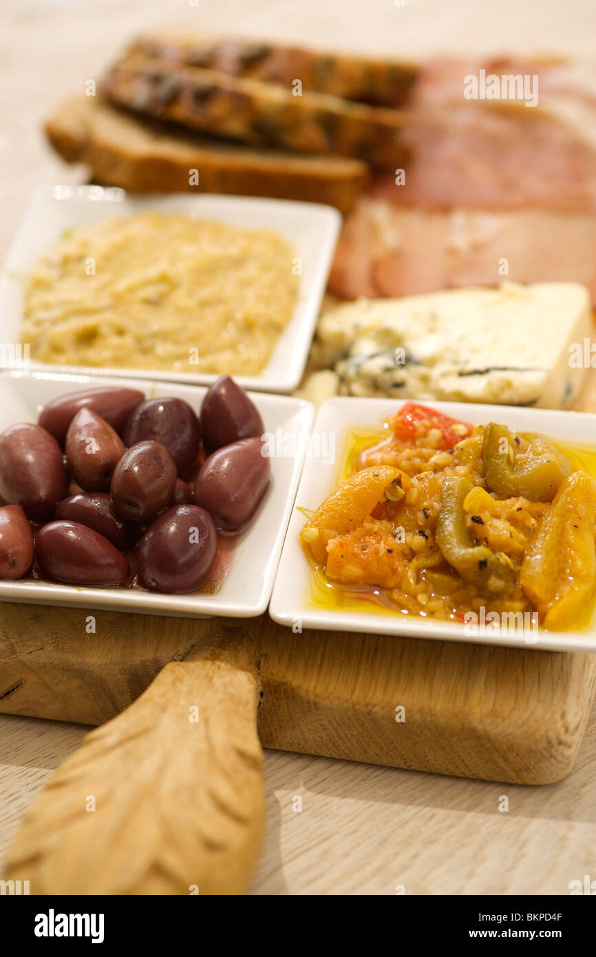 Platte mit Snacks wie Kalamata-Oliven, Humus, Blauschimmelkäse, Paprika und Sonnenblumen Samen Brot. Stockfoto