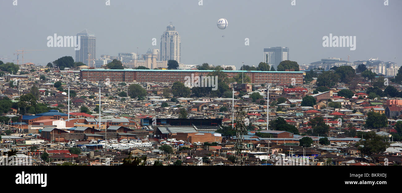 Schauen Sie über Township Alexandra auf Luxus Stadtteil Sandton City im Hintergrund mit seinen Hotels und Einkaufszentren Stockfoto