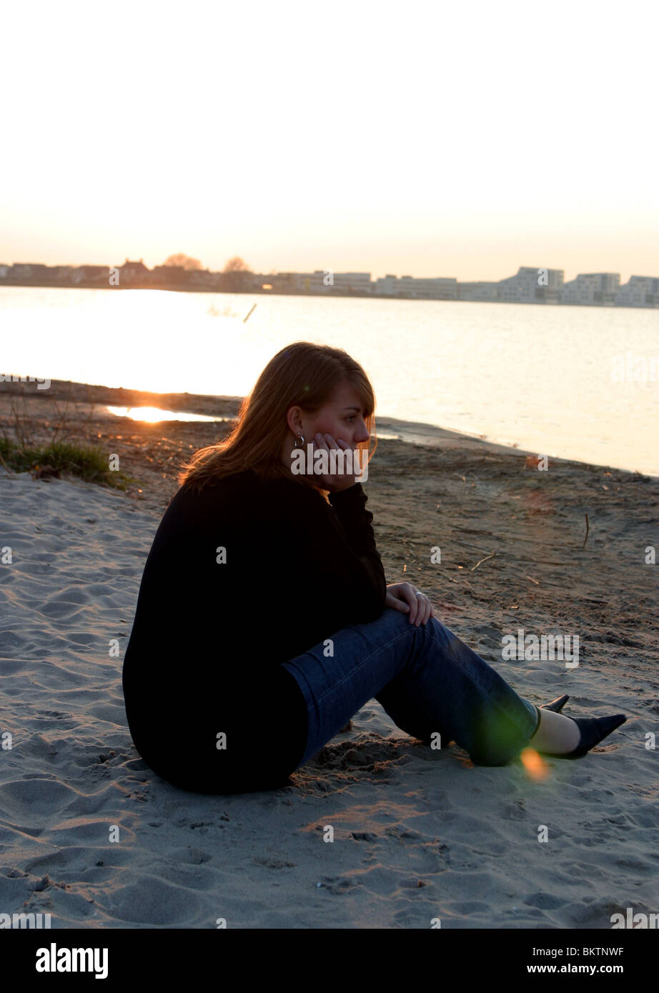 Teenager-Silhouette am Strand denken Stockfoto