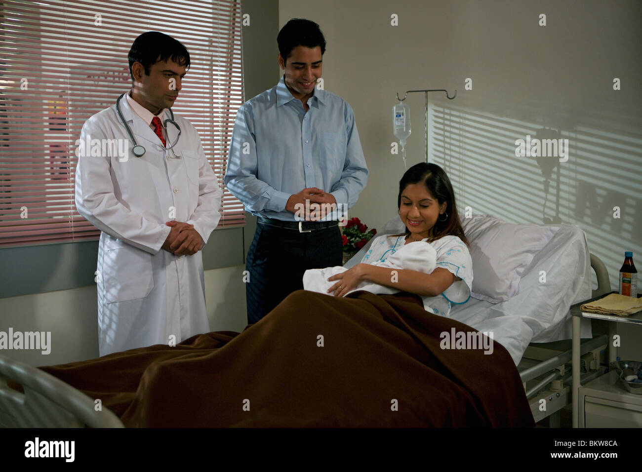 Arzt Besuch der Eltern und Neugeborenen im Krankenzimmer Stockfoto