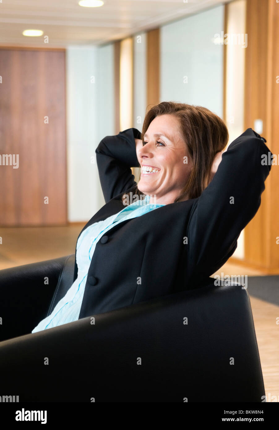 Entspannte Frau im Sessel Stockfoto