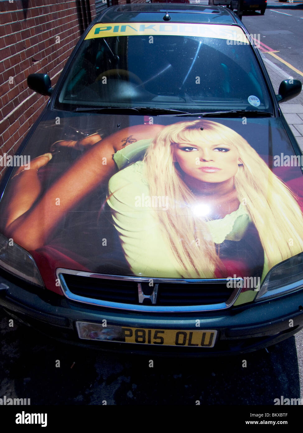 Ein Bizarely maßgeschneiderte Auto hat ein Foto von einer Frau liegend auf der Motorhaube. London Stockfoto