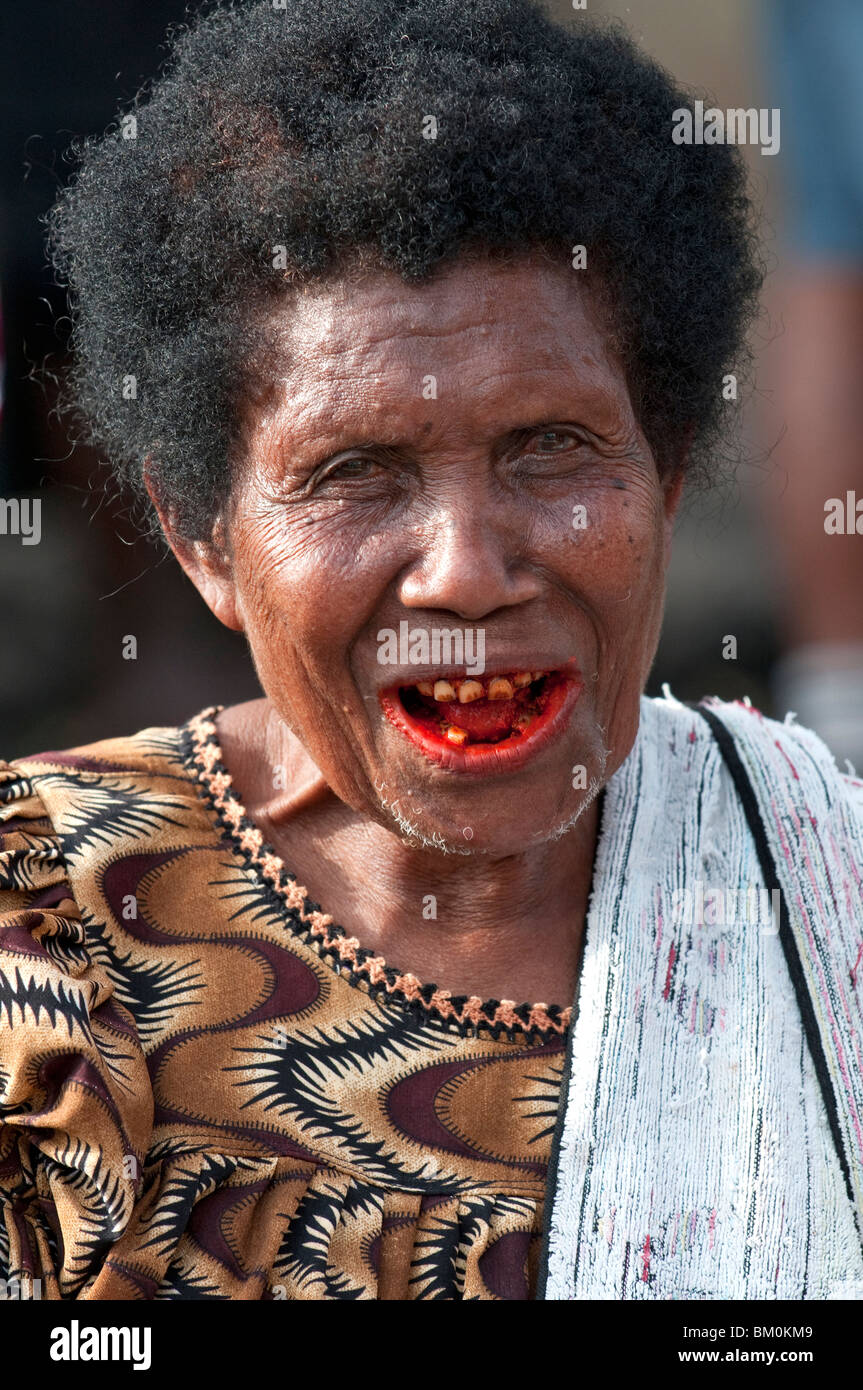 Eine alte Dame am Straßenrand Anbieter, ihre Zähne gefärbt rot aus der Tradition des Kauens Areca (Betel) Mutter. Stockfoto