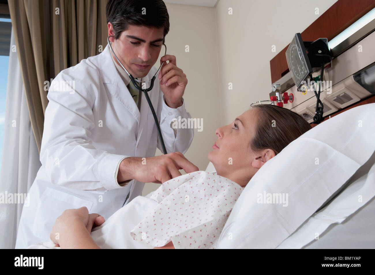 Arzt untersucht eine Frau Stockfoto