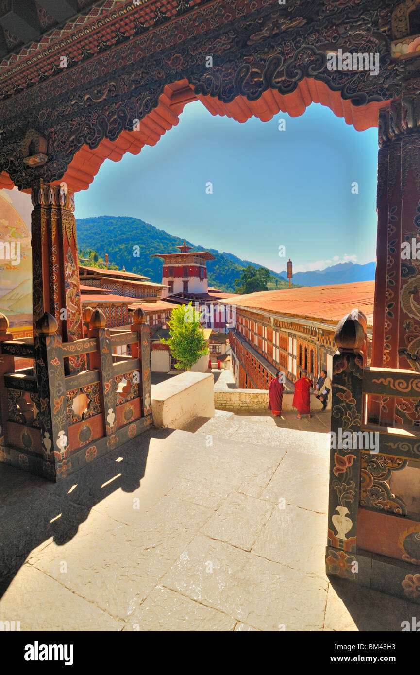 Blick vom Tempel über Innenhof mit Mönchen und Mann in Tracht, Trongsa Dzong, Bhutan. Stockfoto