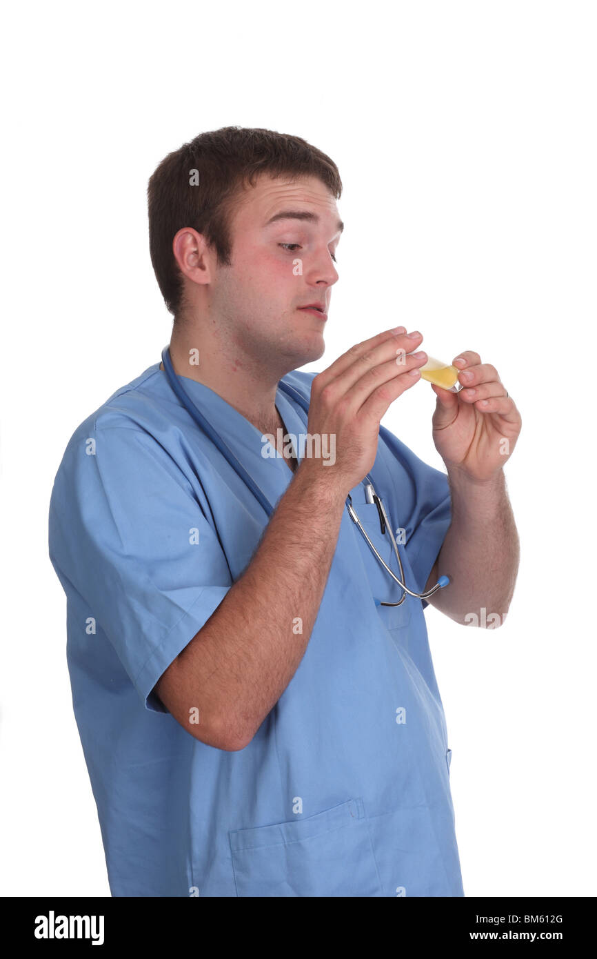 Mai 2010 - junges männliches Modell in medizinischen Schruben als männliche Krankenschwester, Stockfoto