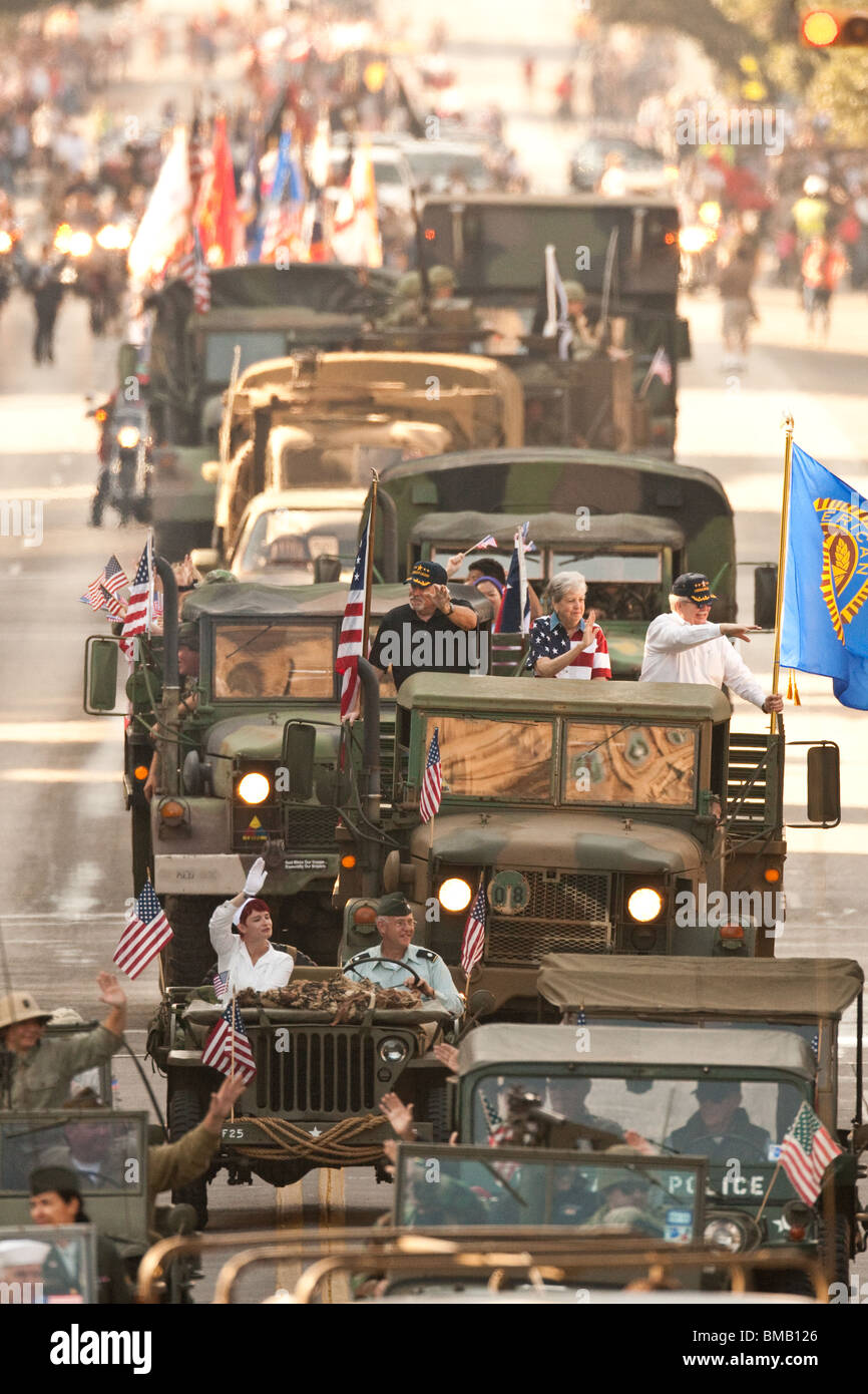 Militär-Veteranen-Welle Zuschauern von militärischen Fahrzeugen während der jährlichen Veterans Day Parade durch die Innenstadt von Austin, Texas Stockfoto