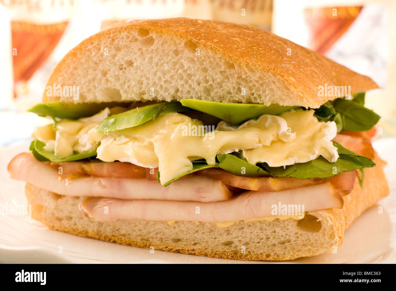 Sandwich mit Avocado, Schinken, Tomaten, Salat und Camembert Käse Stockfoto