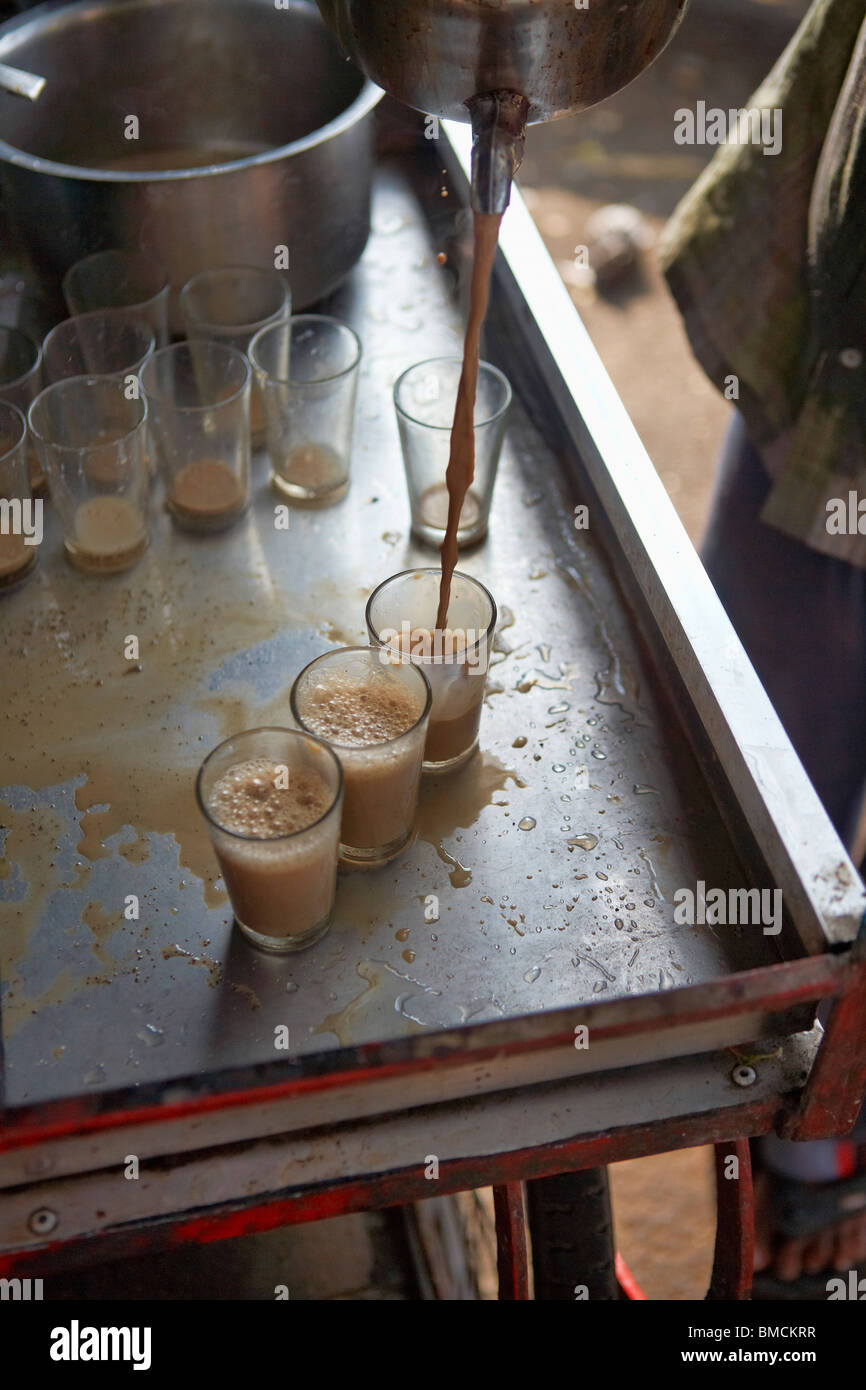 Ein Chai Wallah Gießen Gläser Masala Chai, Mysore, Karnataka, Indien Stockfoto