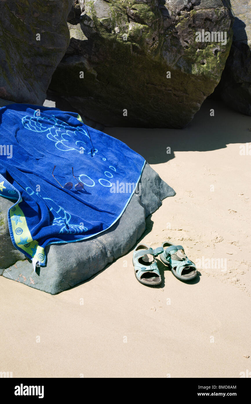 Badetuch und Sandalen an einer sandigen Küste bei Happisburgh. Stockfoto