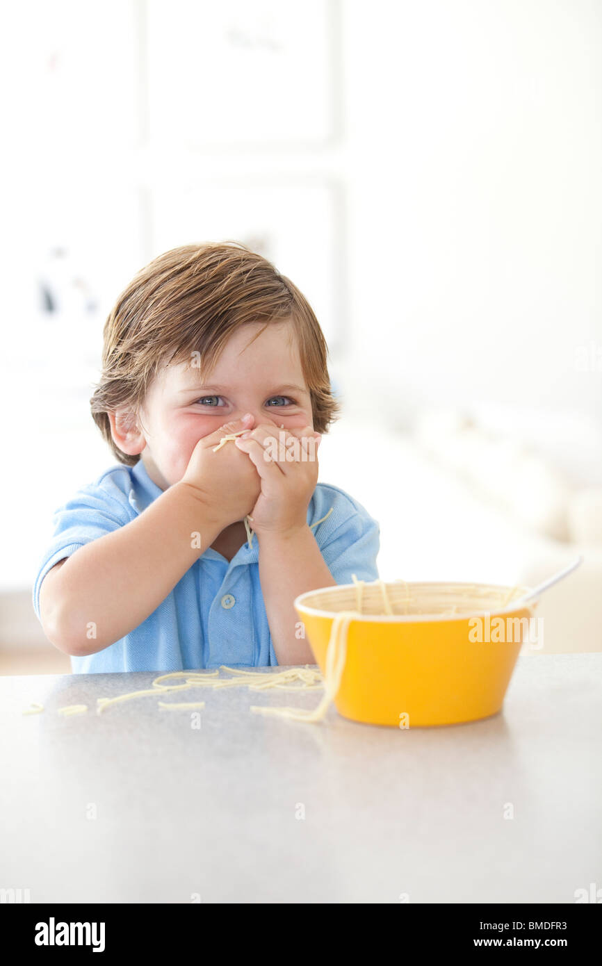 Kleiner Junge essen Nudeln Stockfoto