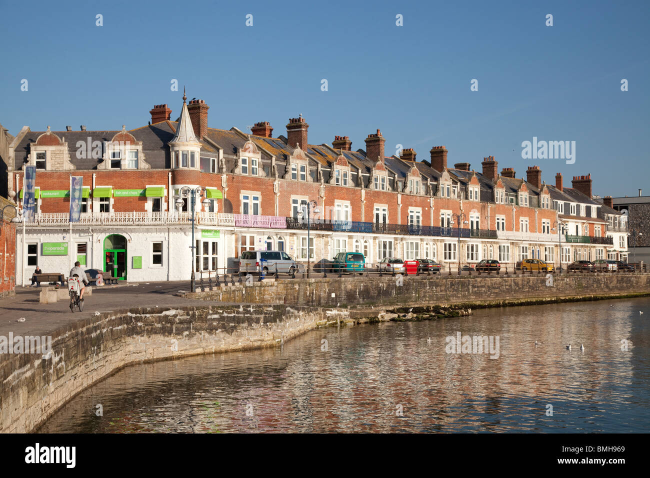 Promenade, Deich, Slipanlage und steinernen Buhnen bei Swanage in der frühen Morgensonne Stockfoto