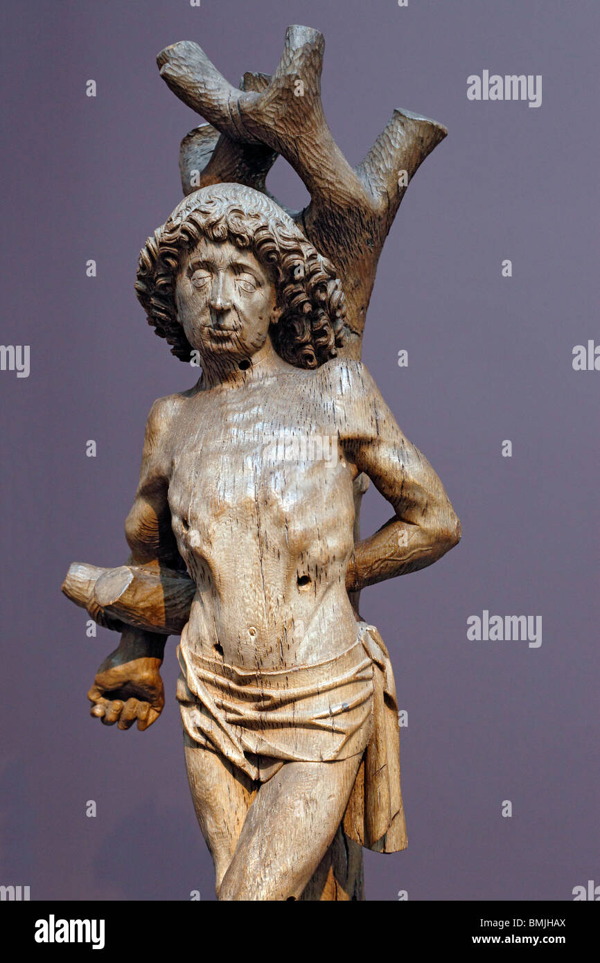 Das Martyrium des Heiligen Sebastian (1480s), hölzerne Skulptur im Museum in Gent, Belgien Stockfoto