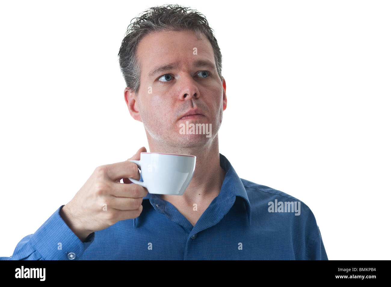 Ein Mann in einem blauen Kleid Shirt, hält einen kleinen Cappuccino / Coffee Cup, isoliert auf weiss. Stockfoto