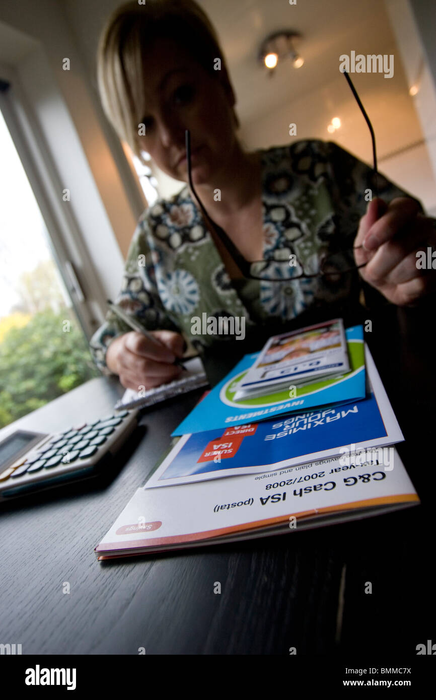 Frau ISA individuelle Sparkonto Flugblätter, um beste Konto für ihre Bedürfnisse entscheiden zu studieren Stockfoto