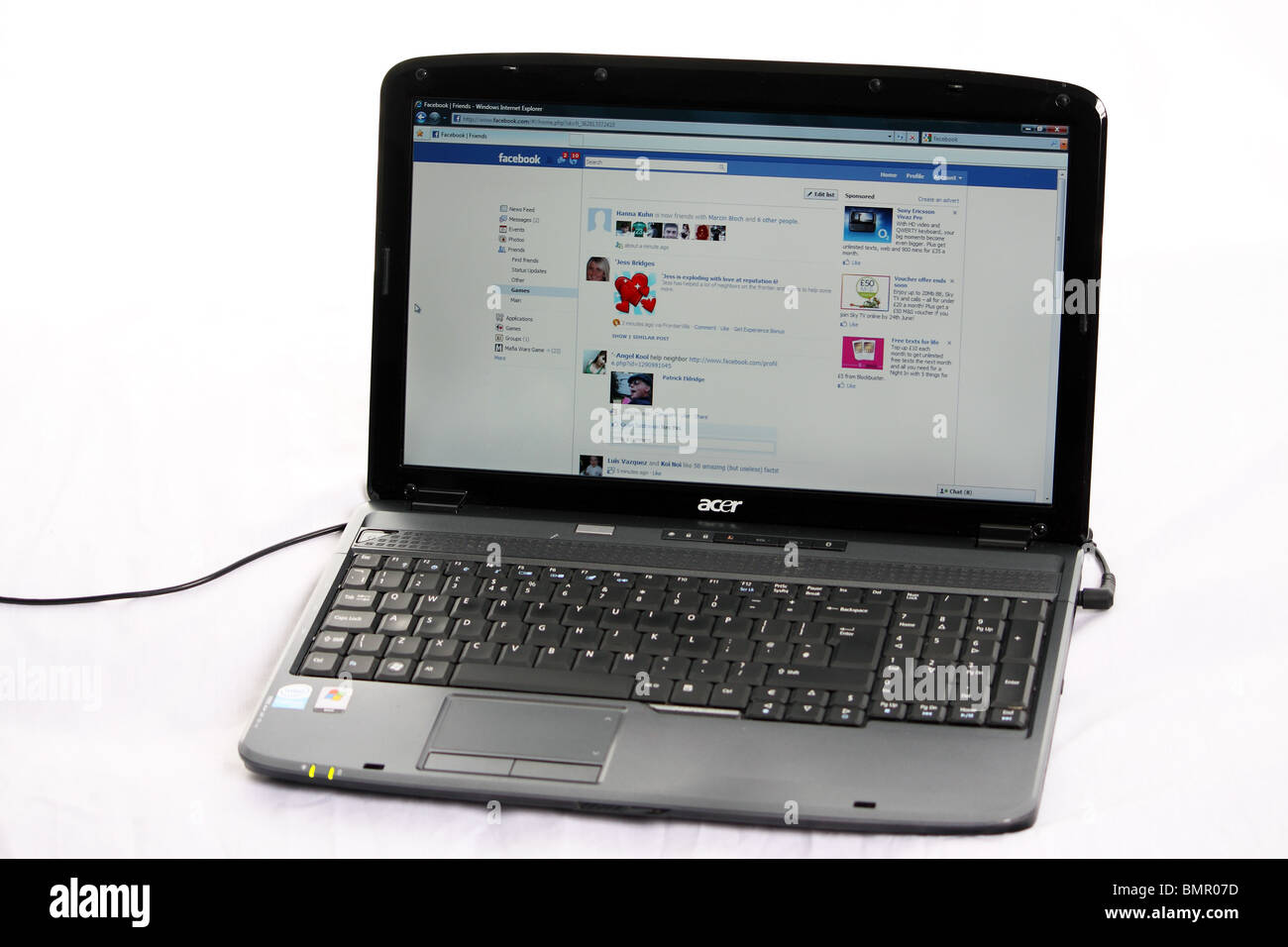Ein Foto zeigt den News feed der Internet Website Facebook; auf ein Acerlaptop genommen auf einem weißen Hintergrund angezeigt Stockfoto