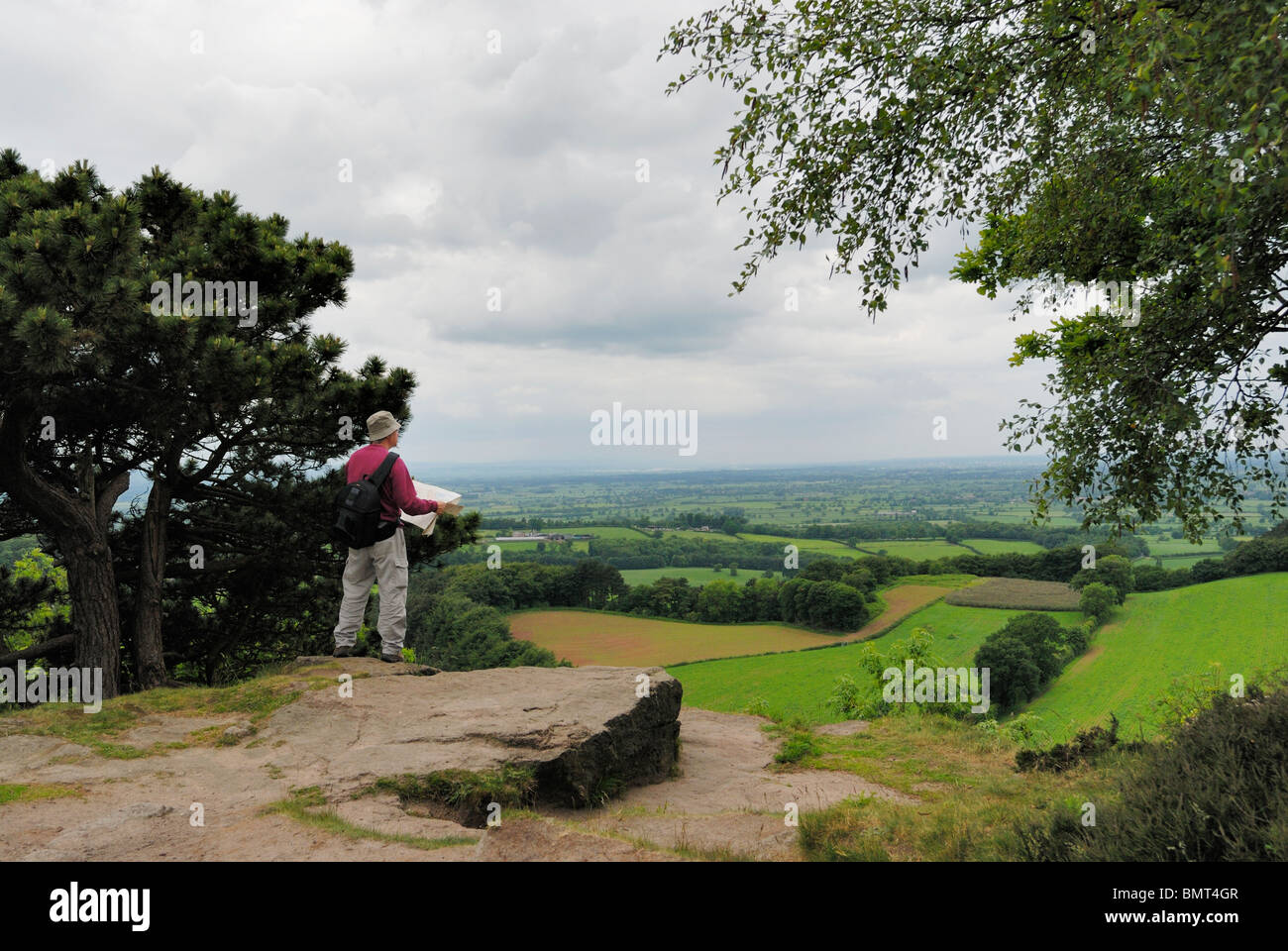 Walker mit Karte genießen Sie den Blick über den Cheshire-Ebenen aus dem Sandstein-Pfad. Stockfoto