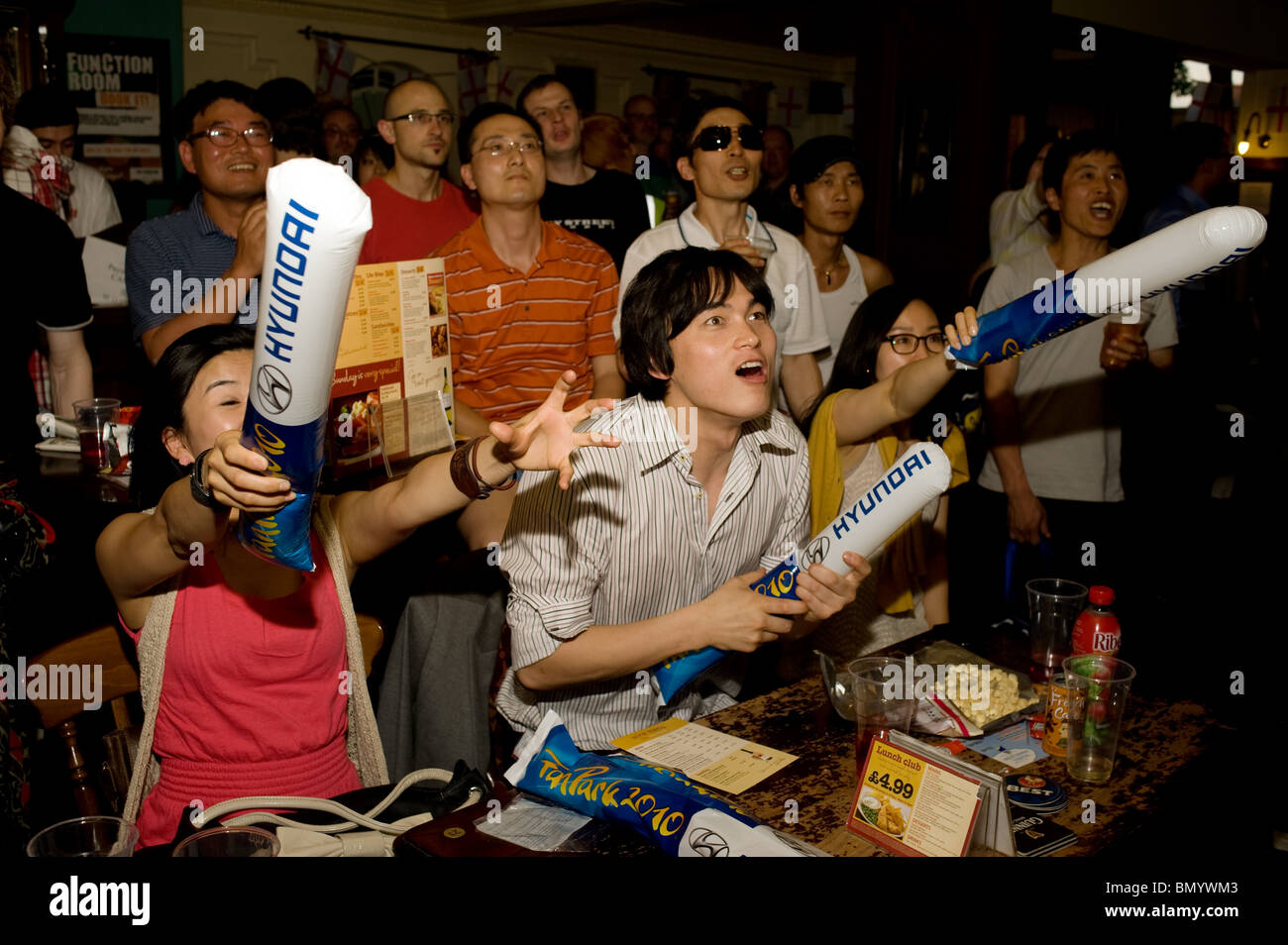 Animiert, begeistert südkoreanische Fußballfans beobachten ihre World Cup Team spielen Nigeria in einem Londoner Pub, UK 2010 Stockfoto