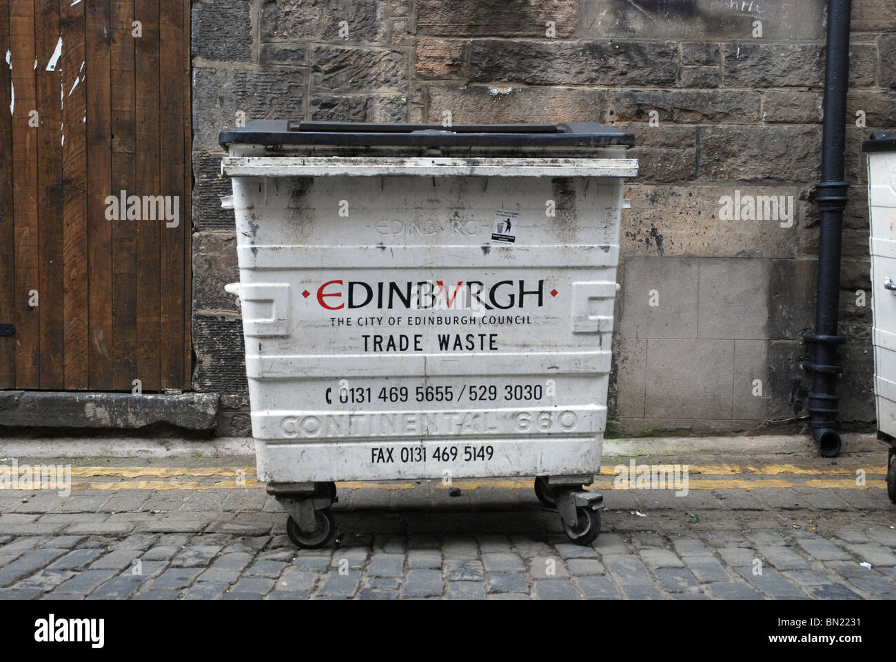 Müllcontainer auf einer gepflasterten Straße in Edinburgh. Stockfoto