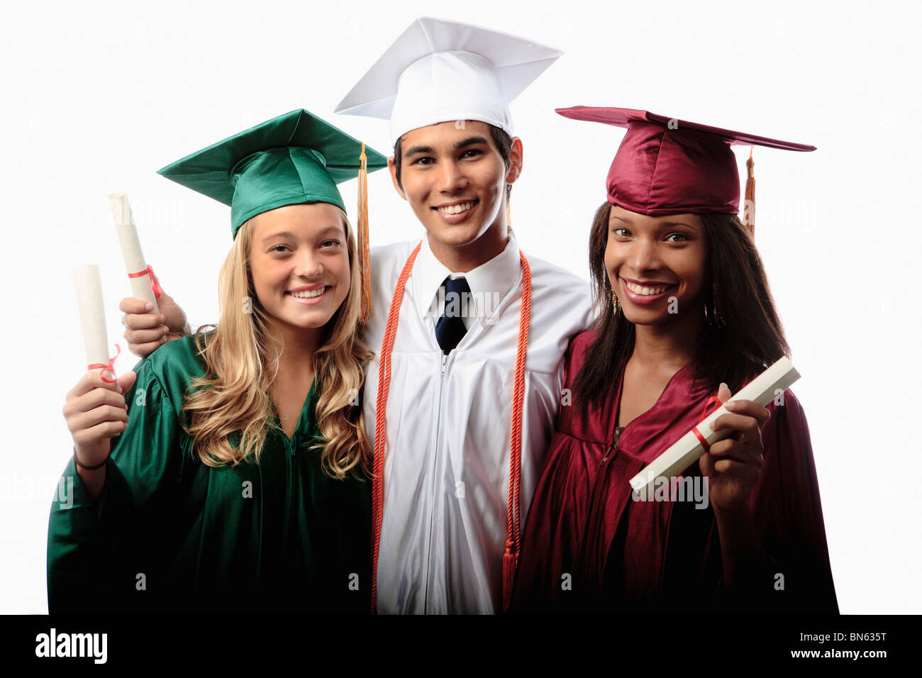 drei Absolventen in Mütze und Mantel mit Diplomen Stockfoto