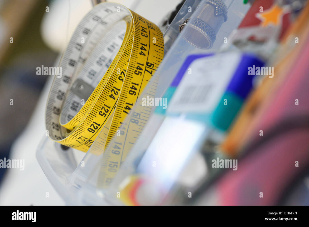 Ein Maßband auf Handarbeiten Bank zusammengerollt. Stockfoto