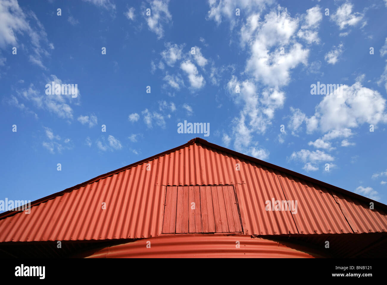 Rote Scheune vor blauem Himmel mit Wolken Stockfoto