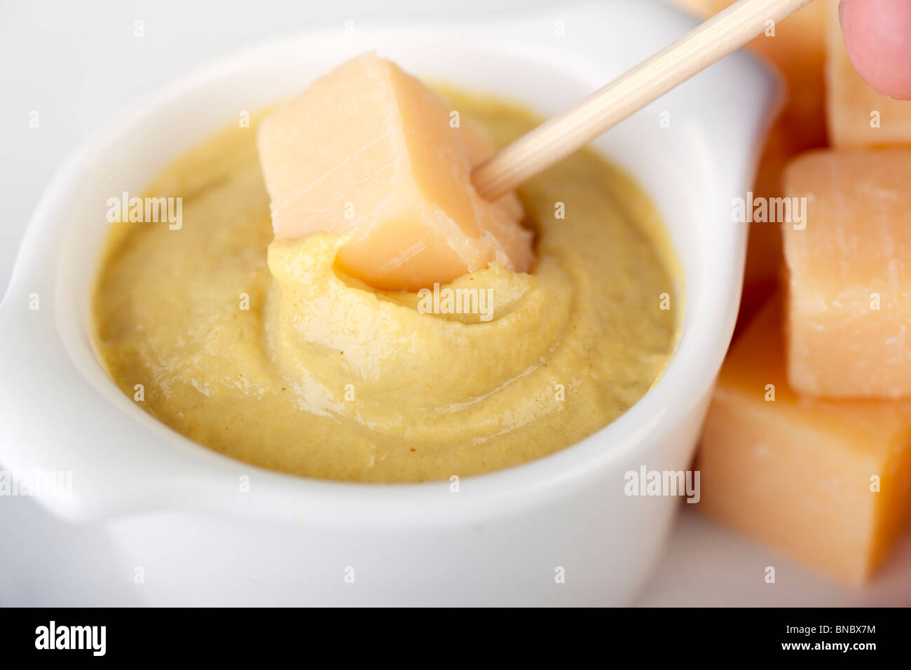 Dutch Treat Käse eingetaucht in würzigen Senf Stockfoto