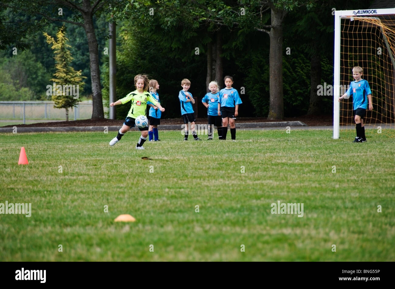 Ein kleines Mädchen kickt den Ball beim Fußball-Camp in Tumwater, Washington. Stockfoto