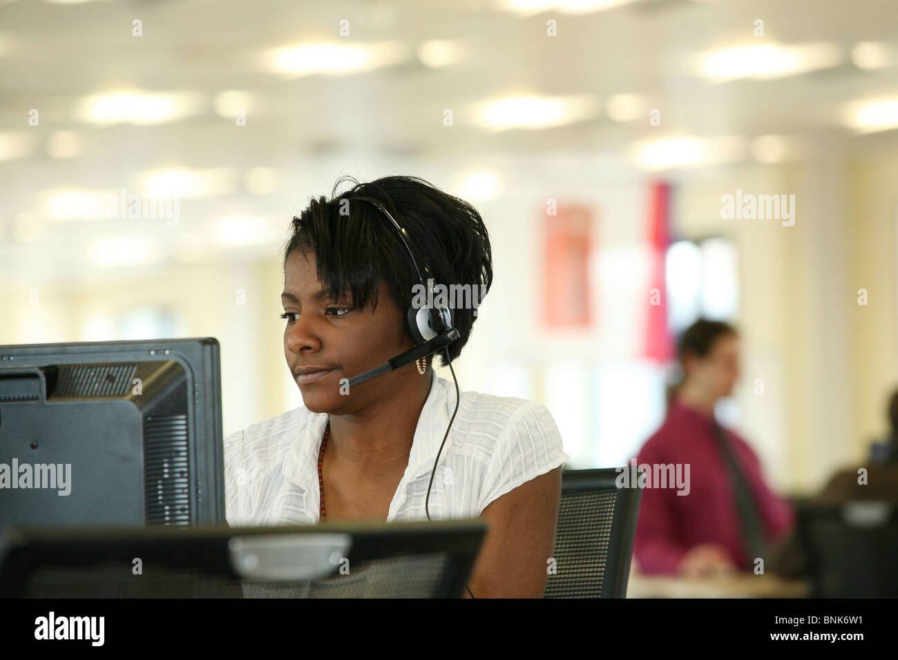 junge Frau, die Arbeit in modernen Callcenter Stockfoto