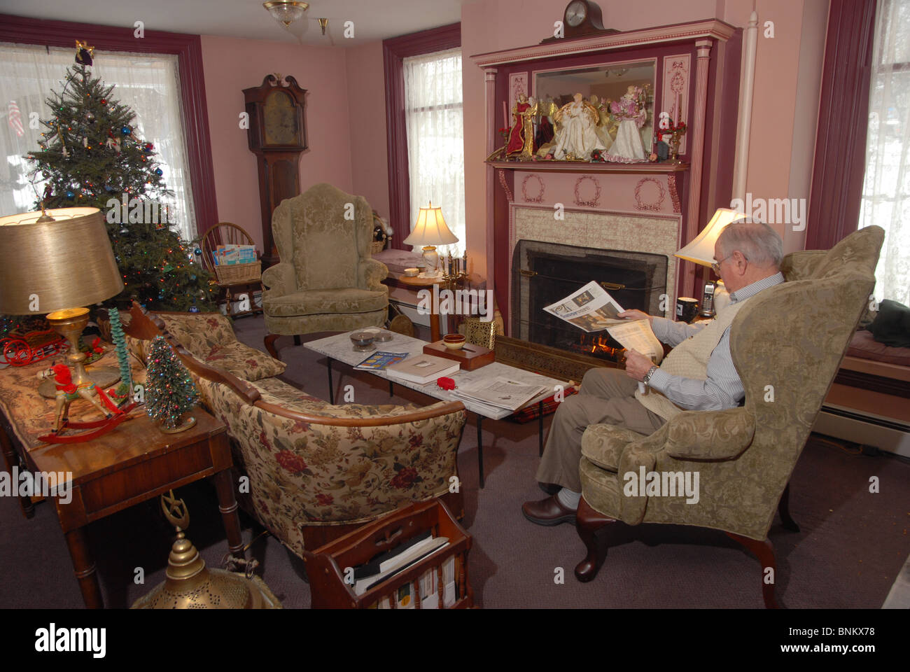 Ein Mann liest eine Zeitung in diesem Land in Waterbury, Vermont während der Weihnachtszeit. Stockfoto